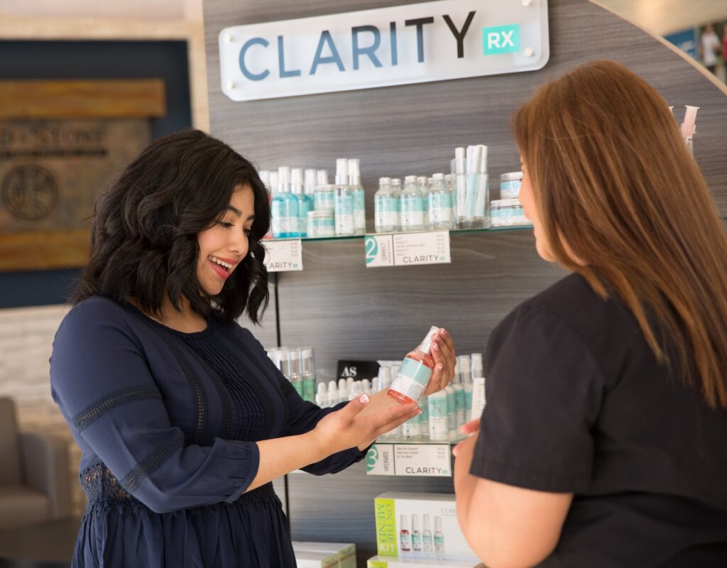 Employee discussing skincare products with a customer