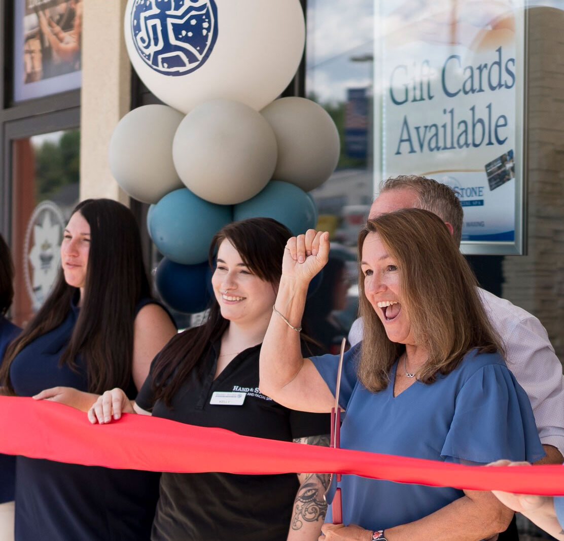 franchise owners in front of store front for grand opening ceremony