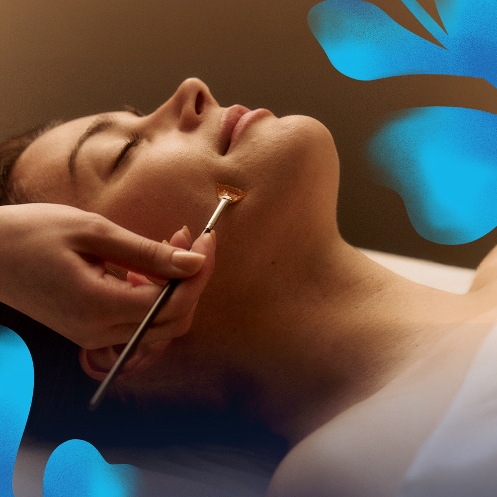 woman receiving facial treatment at Hand & Stone
